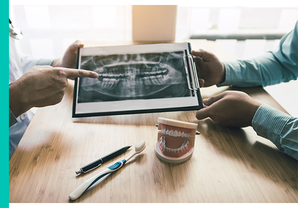 Dr. showing patient dental problems and how to solve them