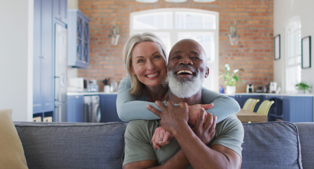 Image of happy couple receiving membership health care and providing a life-changing smile